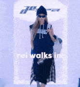 a woman walking down a runway with the words rei walks in above her