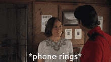 a man in a red shirt is talking to a woman in front of a wanted poster