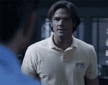 a man wearing a yellow polo shirt that says tech support on it