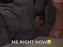 a woman is laying in bed with the words me right now
