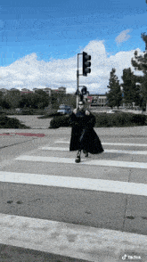 a person crossing a street with a tik tok watermark on the bottom