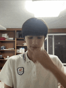 a person wearing a white shirt with a badge on it that says ' seoul '