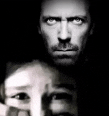 a black and white photo of a man 's face and a woman 's face