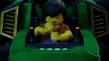 a lego character sitting in a green vehicle