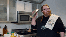 a man in a kitchen wearing a towel that says ' i love you '