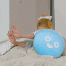a woman is sitting on a bed next to a green pillow with the number 00 on it .