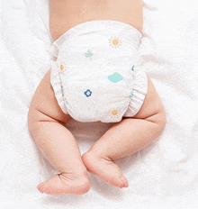 a baby wearing a diaper with flowers and clouds on it