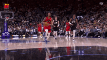 a basketball game is being played in front of a crowd and the scoreboard says 22