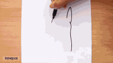 a person is drawing a line on a piece of paper with drawbook written on it