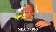 a man in a leather jacket is laying down with a spoon in his mouth and the words me gorpio on the bottom