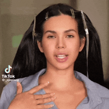 a woman with clips in her hair is making a funny face