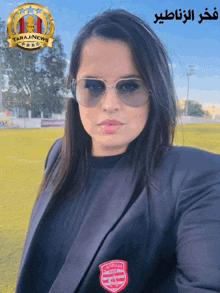 a woman wearing sunglasses and a jacket with the word tarajinews on it