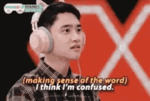 a young man wearing headphones with cat ears is making a funny face .