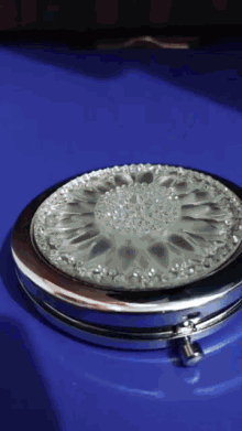 a round mirror with a flower design on it