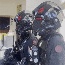 two stormtroopers are standing next to each other in front of a sign that says " sortie "