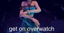 a woman in a blue dress is holding a light in her hand and the words `` get on overwatch '' are on a blue background .