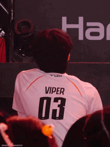 a man wearing a white jersey with viper 03 on the back