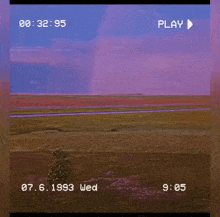 a play button is on a video that shows a landscape