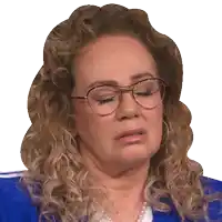a woman with curly hair wearing glasses and pearls