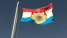 a red white and blue flag with a coat of arms
