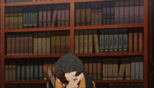 a man with the letter n on his jacket stands in front of a bookshelf full of books