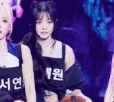 a girl wearing a black tank top with chinese writing on it