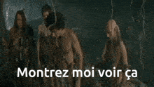 a group of men standing next to each other with the words montrez moi voir ca on the bottom right