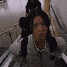 a girl with a backpack is walking up a set of stairs