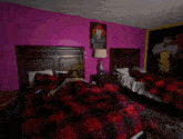 a man is laying in a bed with a picture of pennywise on the wall above him