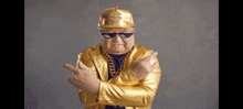 a man in a gold suit is wearing sunglasses and a hat with a dollar sign on it