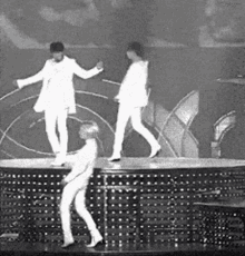 a group of people are dancing on a stage