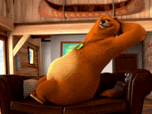 a cartoon bear is sitting on a couch in a room