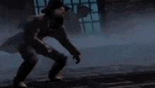 a man in a trench coat is standing in a dark room .