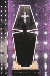 a black coffin with a white cross on top of it