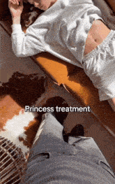 a woman laying on a couch with the words " princess treatment " on the bottom of the photo