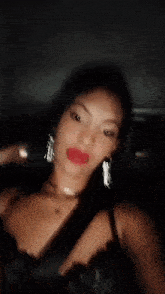 a woman is taking a selfie in a car at night .