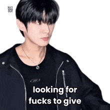a young man wearing a black jacket and a necklace is looking for fucks to give