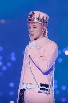 a person wearing a pink suit and a crown on top