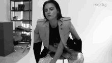 a black and white photo of a woman with the word maxim on the bottom left