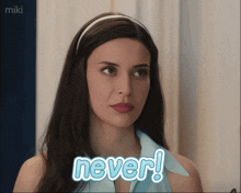 a woman in a blue shirt with the word never on it