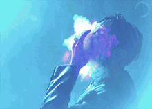 a man smoking a cigarette with a blue and purple background
