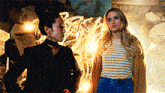 two women are standing next to each other in a room with a spider web in the background .
