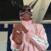 a person wearing a bunny mask and sunglasses