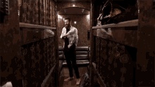 a man in a plaid shirt is standing in a room with a couch