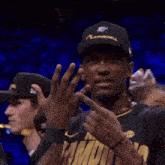 a man wearing a hat and a shirt that says ' champs ' on it