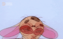 a close up of a cartoon character with pink ears making a funny face .