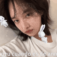 a girl with a bunny on her face and the words gyu cuando es de ann below