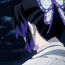 a close up of a person 's back with a butterfly in their hair .