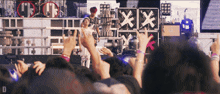 a crowd of people at a concert with the letter d in the corner