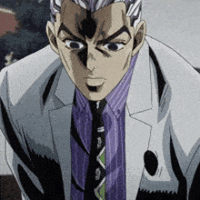 a man in a suit and tie looks at the camera